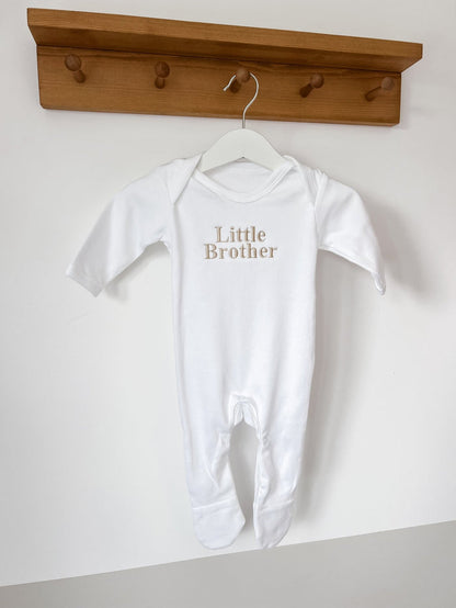 White footed baby sleepsuit with short sleeves and 'Little Brother' front lettering