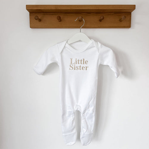White baby sleepsuit with long sleeves and Little Sister chest print