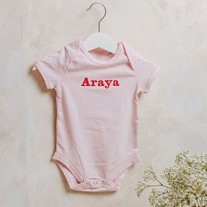 Light pink embroidered baby bodysuit, short sleeves, Araya name