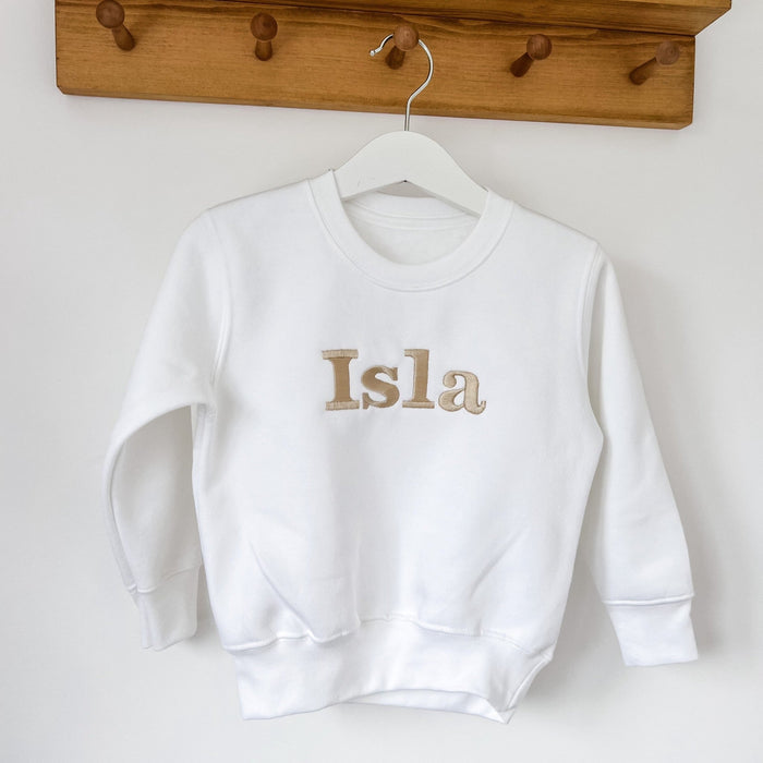 White long-sleeve sweatshirt with “Isla” front print, on hanger