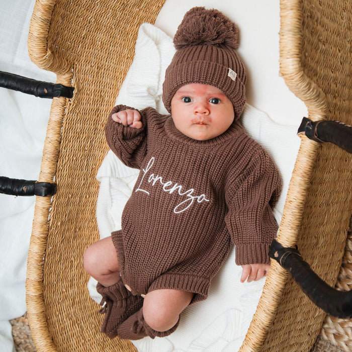 Personalised knitted romper in dark brown with beanie pom-pom, 'lorenzo' on chest