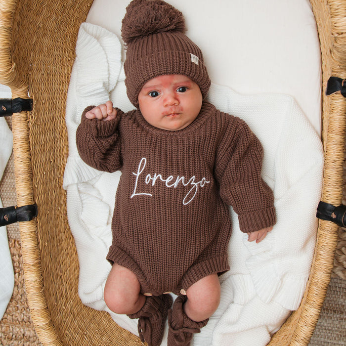 Dark brown knitted baby romper with matching beanie pom-pom, 'lorenzo' front detail