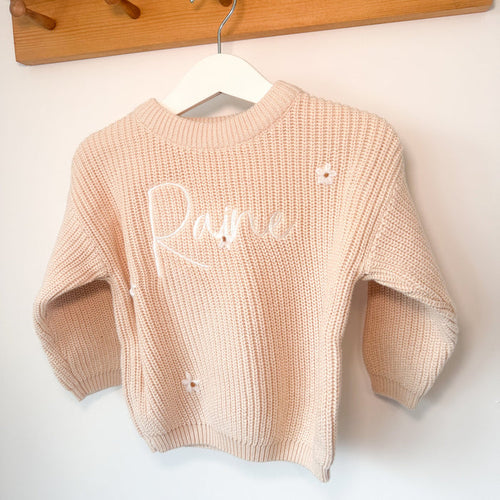 Cream knitted jumper with long sleeves, crew neck, and white script name detail