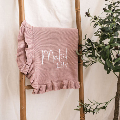 Dusty pink personalised knit blanket, frilled edges, “Mabel Lily” stitched in white