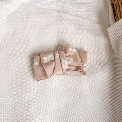 Floral knitted headtie bow, pale pink with white floral motifs