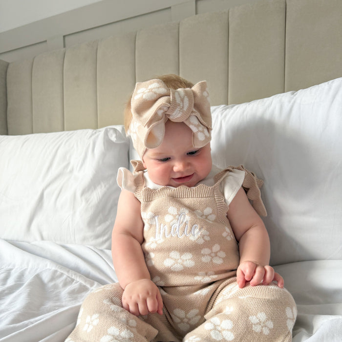 Floral knitted headtie bow on baby, pale pink with white flower print