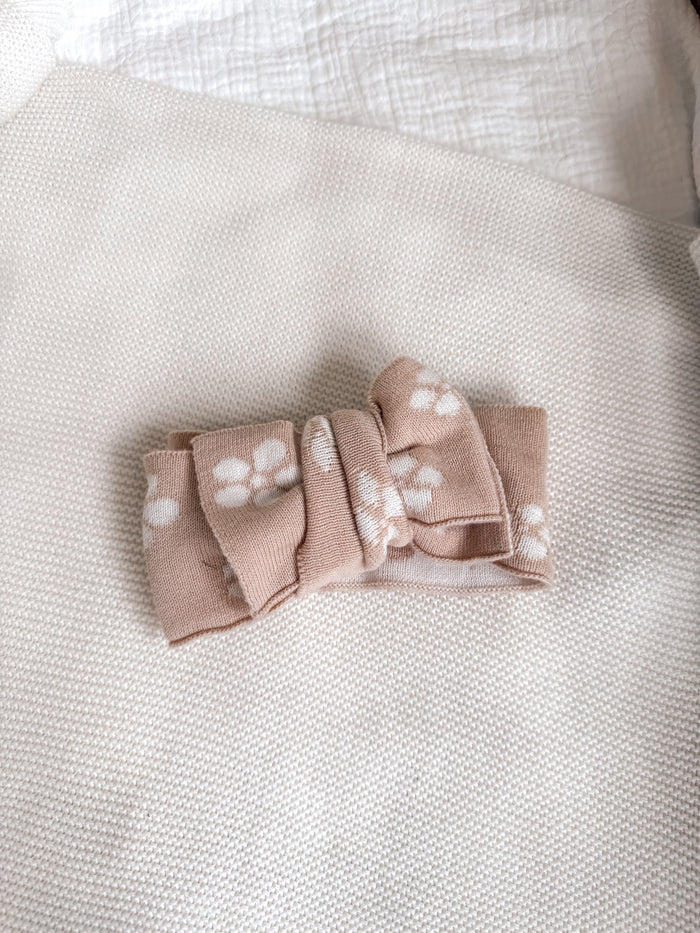Floral knitted headtie bow, pale pink with white flower pattern