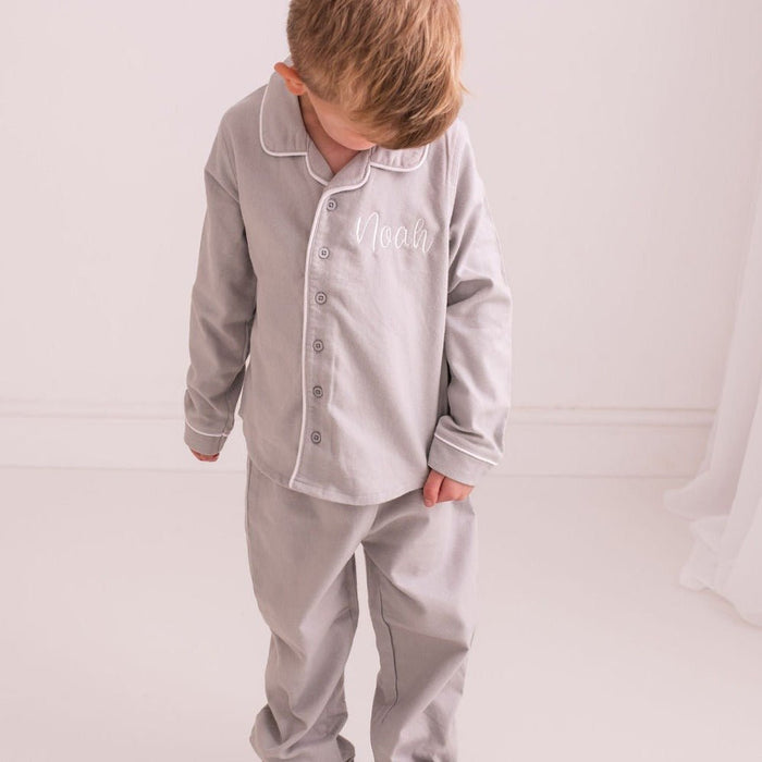 Grey pajama set with long sleeves and button front; embroidered 'Noah' on shirt.