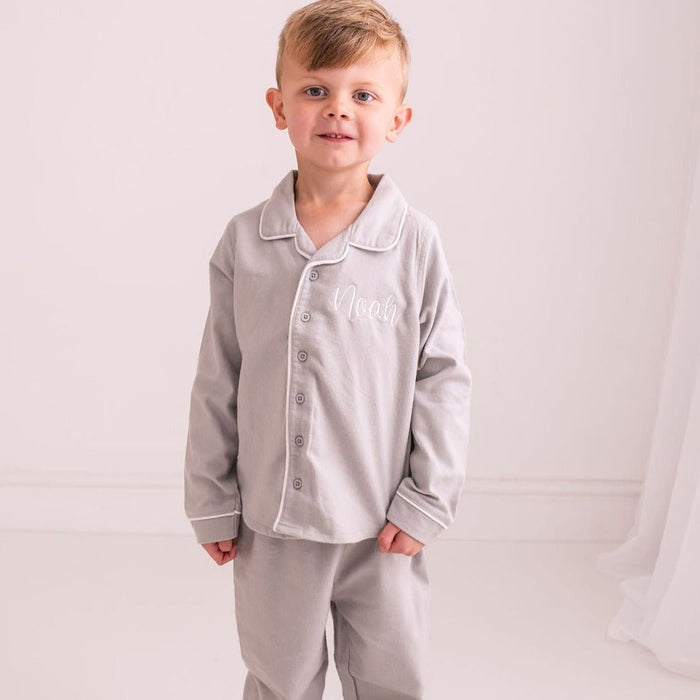 Grey kids' pajama set with button-front shirt and matching trousers; 'Noah' embroidery.