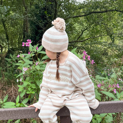 Knitted stripe beanie with pom-pom on top, beige and white ribbed stripes