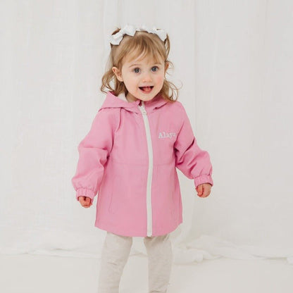 Pink lightweight rain coat with hood, front zip, long sleeves and elastic cuffs