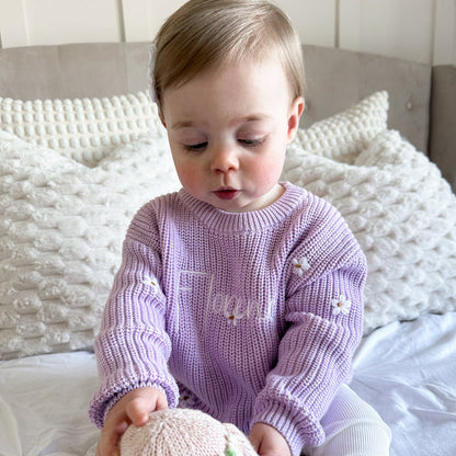 Lilac knitted baby jumper with ribbed crew neck, cuffs, and embroidered script with florals