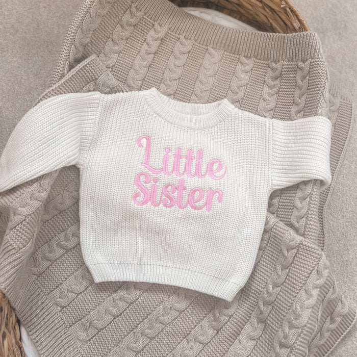 Crew-neck knitted child jumper in cream with pink 'Little Sister' text