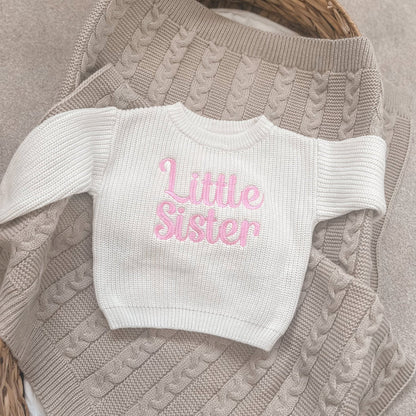 Crew-neck knitted child jumper in cream with pink 'Little Sister' text