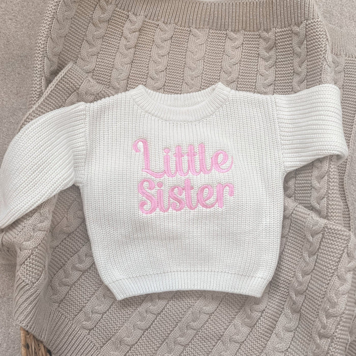 Personalised knitted child jumper in cream with pink 'Little Sister' lettering