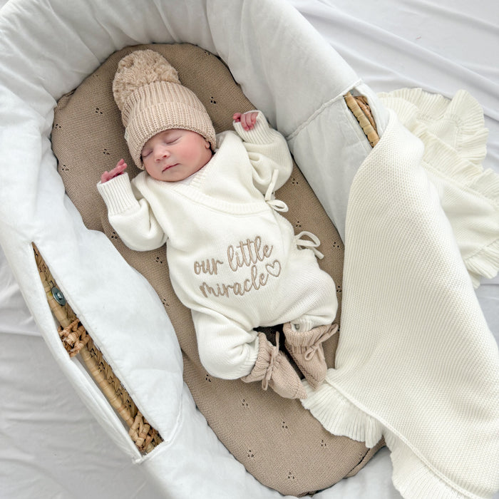 Cream long romper with “our little miracle” print, loose sleeves and tie neckline