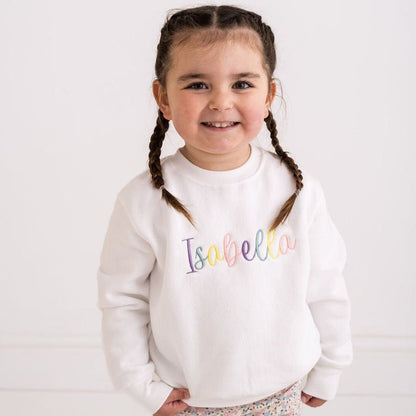 White sweatshirt with multicolor embroidered name Isabela on front