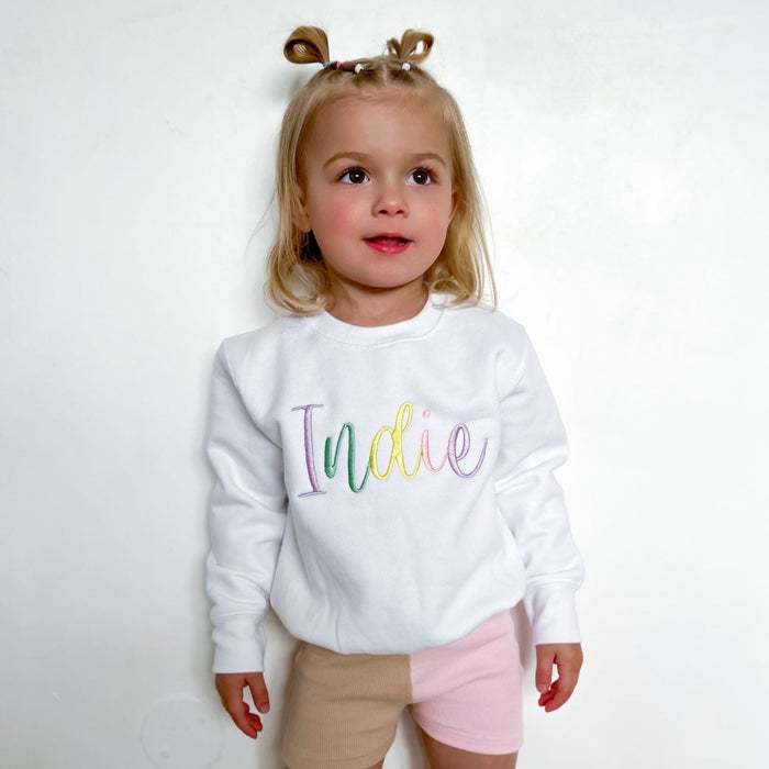 White sweatshirt with multicolor embroidered name Indie on front
