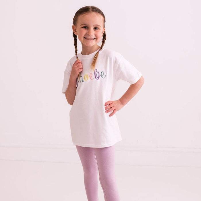 White T-shirt with pastel script embroidery; short sleeves and crew neckline