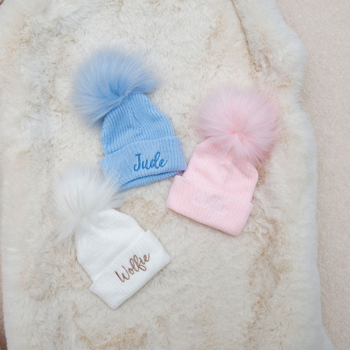 Baby rib-knit pom hat, light blue with “Jude” and fluffy blue pom