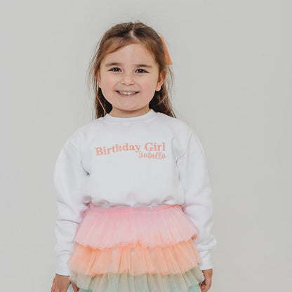 White kids sweater with Birthday Girl text graphic and name on chest