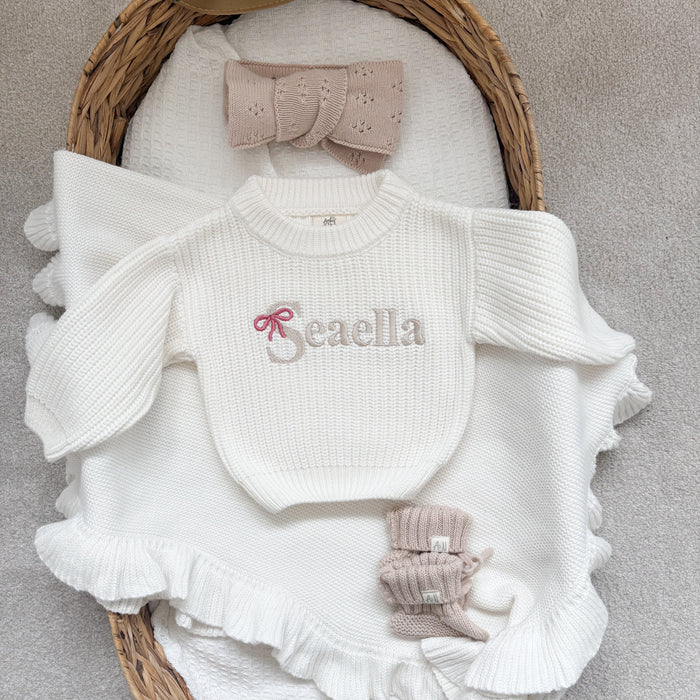 White chunky knitted jumper with ruffle sleeves, front bow-name logo 'Beaella'