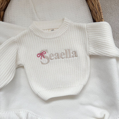 White knitted jumper with 'Beaella' bow-name logo and textured crew neckline