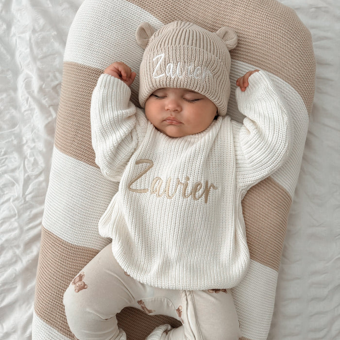 Cream chunky knit jumper with 'Zavier' and matching bear hat on baby