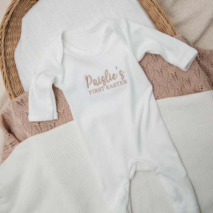 Personalised first Easter sleepsuit, white long sleeves with 'Paislie's First Easter' logo