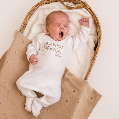 White baby sleepsuit with long sleeves, 'Our First Father's Day' print and Regan name