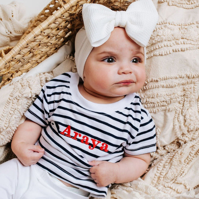 Striped baby T-shirt in navy and white with red 'Araya' print, short sleeves