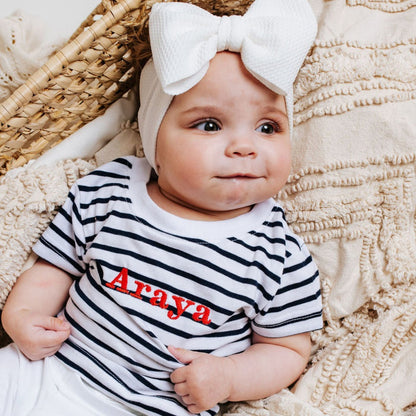 Striped baby T-shirt in navy and white with red 'Araya' print, short sleeves