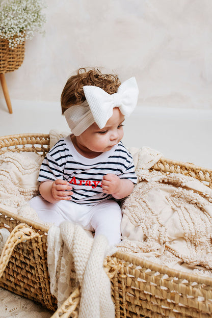 Striped baby T-shirt in navy and white with red 'Araya' text, short sleeves