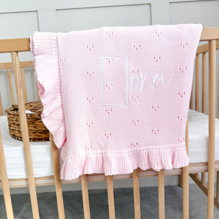 Pink pointelle blanket with ruffled hem and personalised logo-style name panel