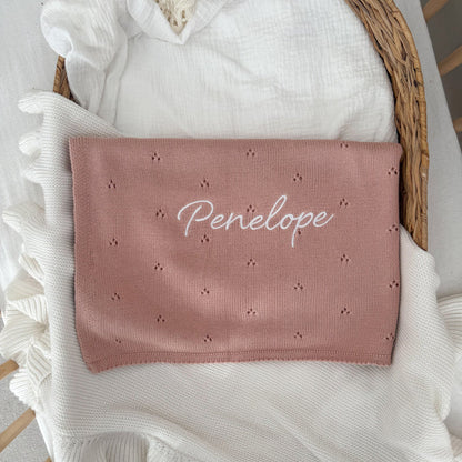 Pink personalised baby knit blanket with "Penelope" script and dot star motifs