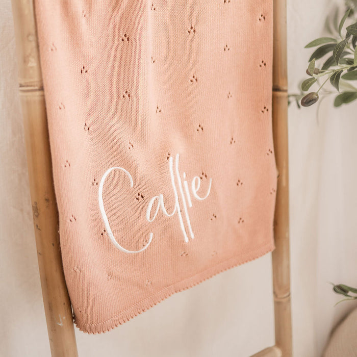 Personalized baby knit blanket close-up, pink pointelle with 'Calle' embroidery