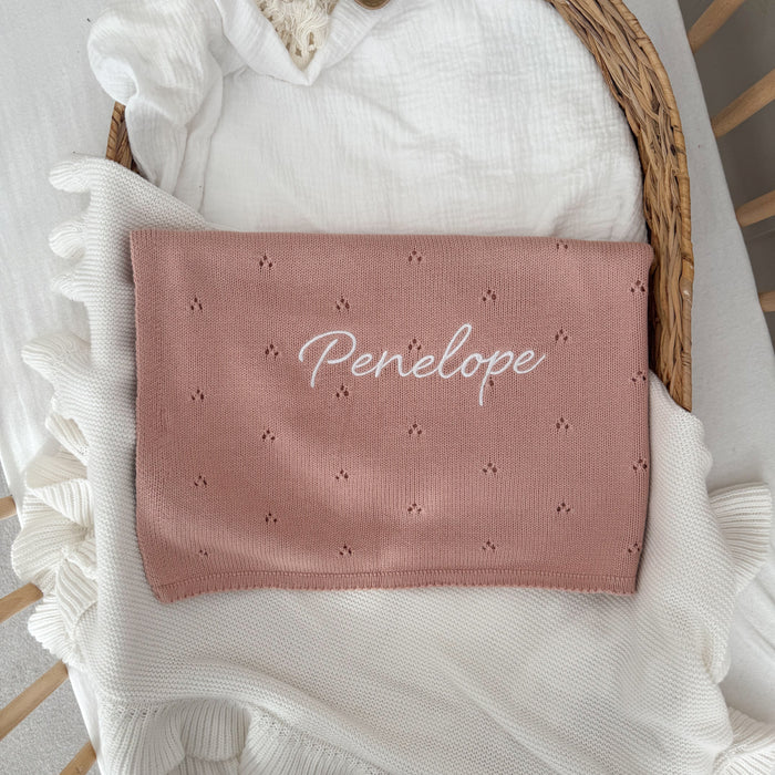 Pink pointelle baby blanket featuring "Penelope" name in cursive and tiny stars