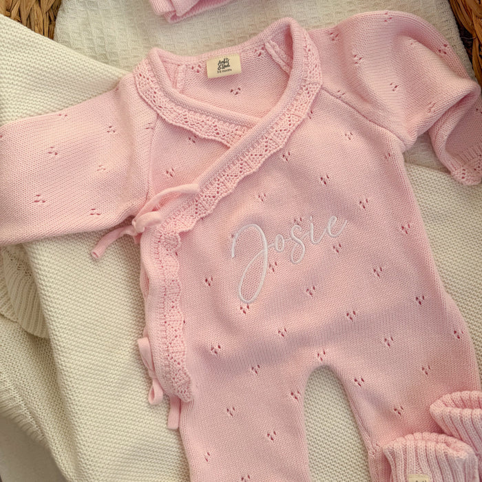 Pink pointelle kimono romper with lace trim and embroidered name detail.