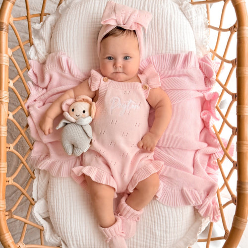Pink pointelle summer romper with bow headband, ruffled legs, and plush bunny