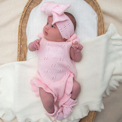 Pink pointelle summer romper with ruffled leg openings and bow headband detail