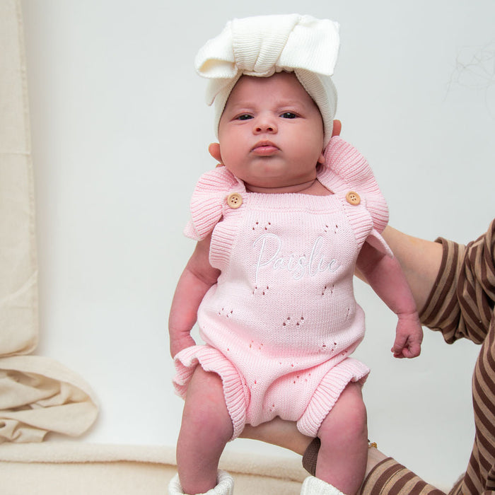 Pink pointelle summer romper with button straps and bow headband