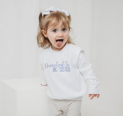 White kids sweater with "Promoted to BIG SISTER" print, long sleeves
