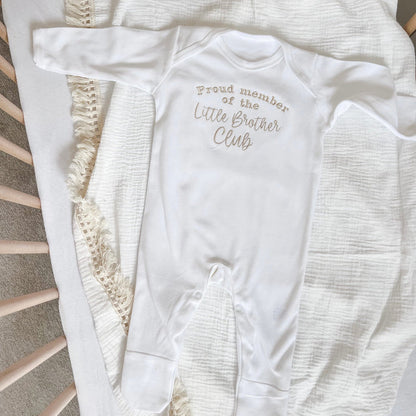 White baby long-sleeve romper with “Little Brother Club” print and button snaps