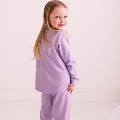 Purple pajama set with long-sleeve top and matching pants, side profile