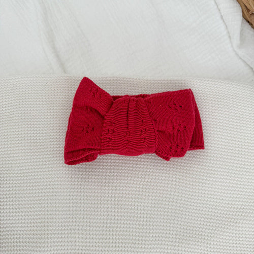 Red knit bow headband with pointelle texture, centered bow