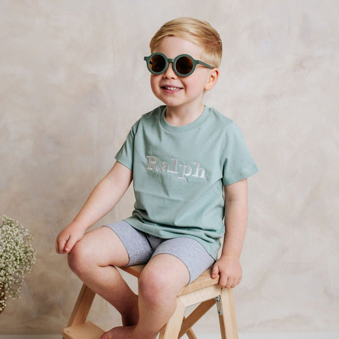 Sage green personalized T-shirt with 'Ralph' printed front, worn by child