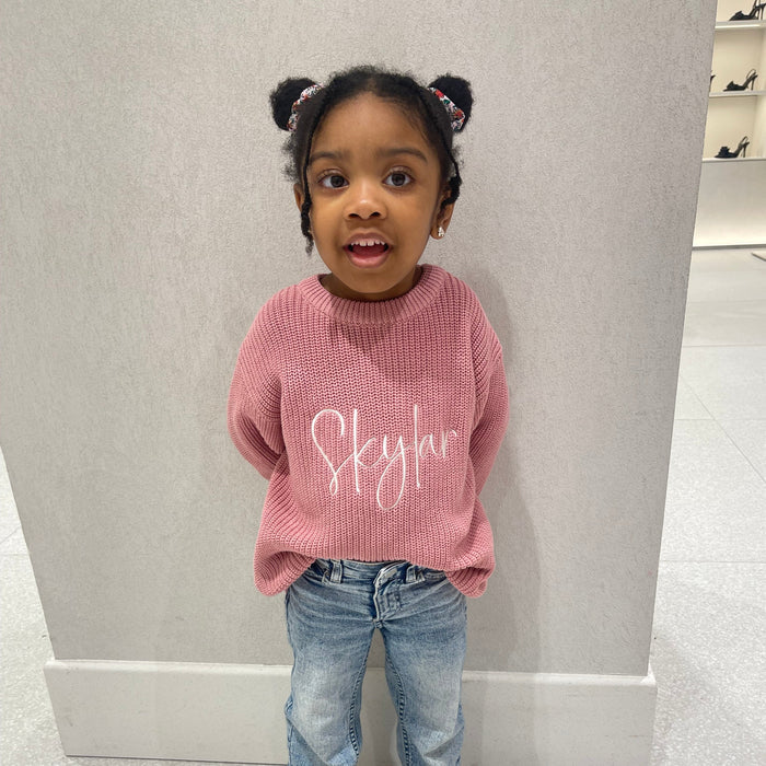 Pink knitted jumper with white script print, crew neck, ribbed cuffs and hem