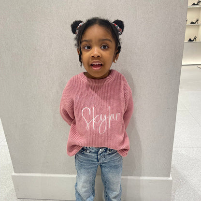 Pink knitted jumper with white script print, crew neck, ribbed cuffs and hem