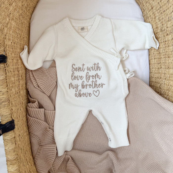 Cream knitted baby romper with embroidered love message and tan side panel, short sleeves