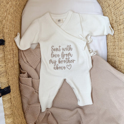 Cream knitted baby romper with embroidered love message and tan side panel, short sleeves